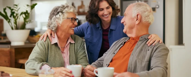 Conversations That Heal - Senior woman smiling and engaging in conversation with parents in a memory care.