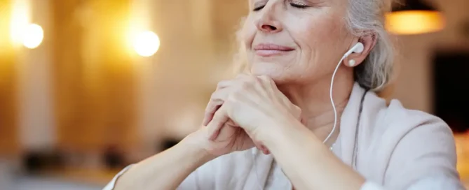 Resident senior listening to favorite music in a calm and personalized memory care setting in Medford, OR.