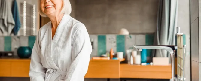 What stage of dementia is not bathing: senior woman in bathrobe sits in bathroom